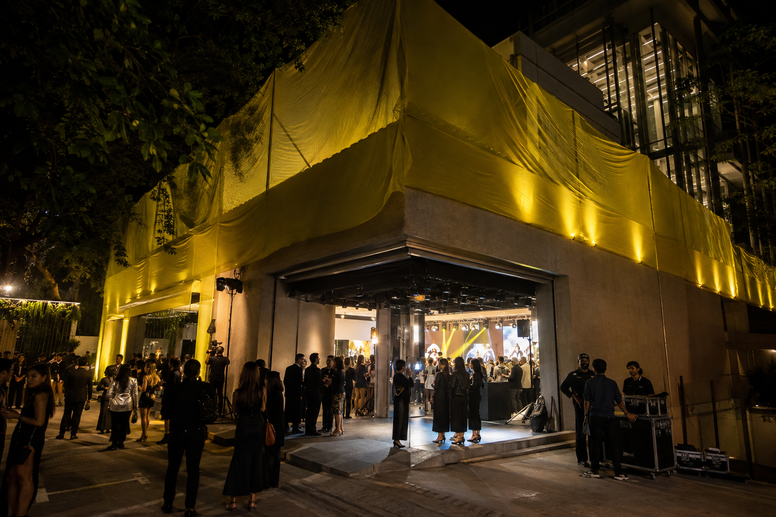 Guests arriving at a yellow-lit flagship store opening